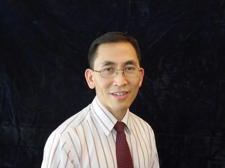 Dr. Youd Sinh Chao, Iu Mien language consultant, wearing a suit
