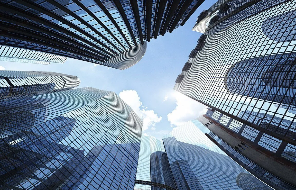 Modern buildings against a blue sky representing organizations seeking language support