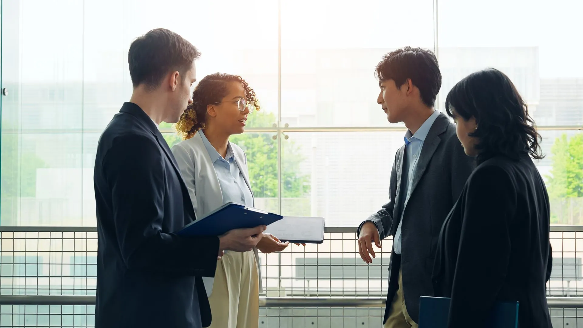 Business professionals conferring in a bright office about interpretation access