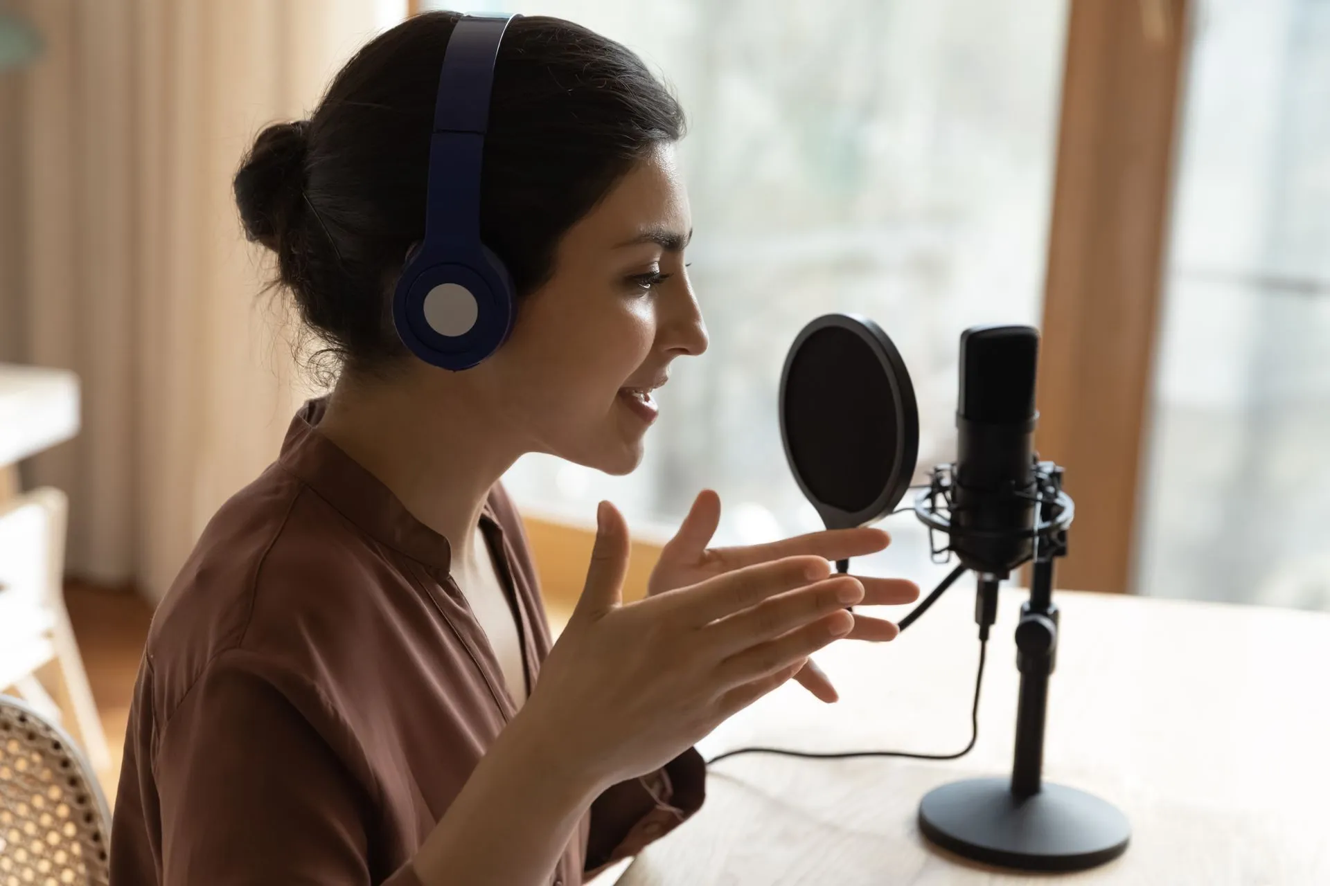 Audio professional recording a voiceover with a microphone for community media